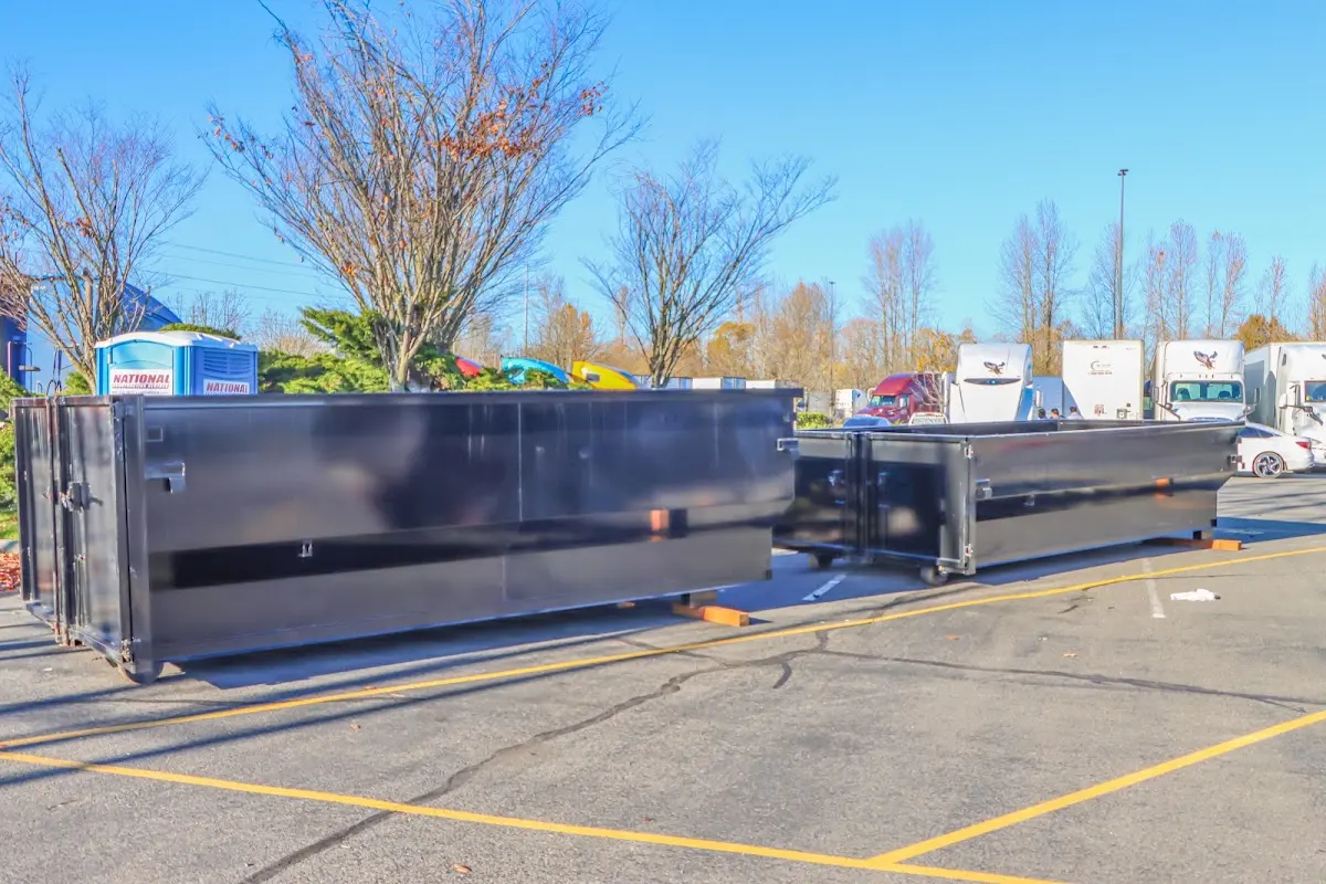 Professional dumpster rental service with roll-off container on residential driveway in Fountainebleau